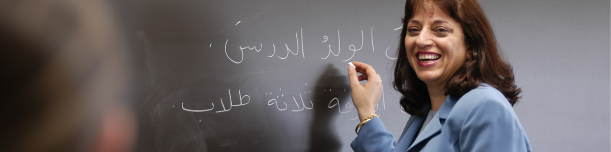 instructor writing on chalkboard